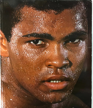 Muhammad Ali Signed Soft Cover Book (Sportscard Guaranty Authentic)