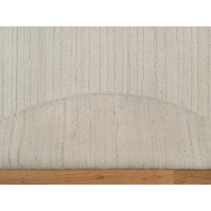 Hand knotted ivory wool with modern tone on tone textured round