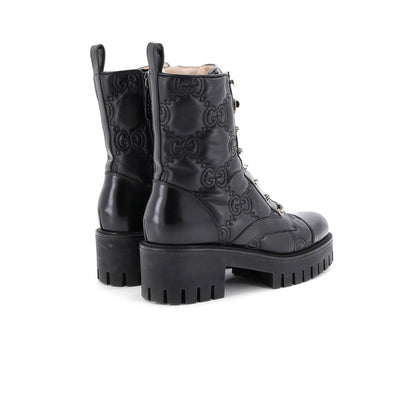 Gucci Women'S Platform Lug Sole Combat Boots Gg Embossed Leather