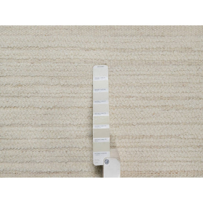 Hand knotted ivory wool with modern tone on tone textured round