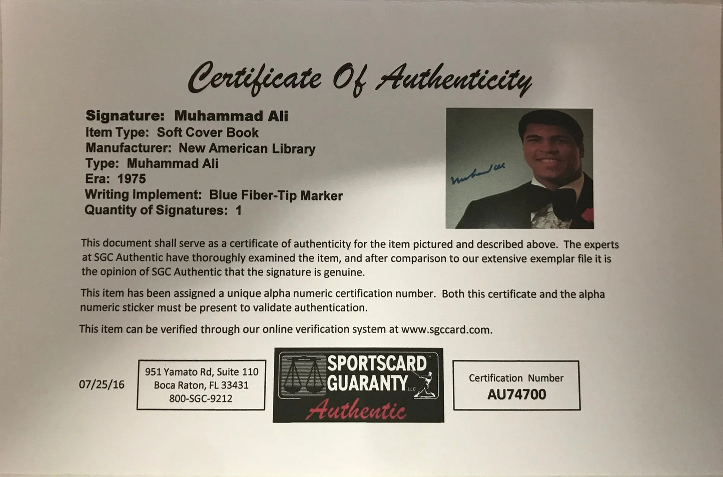 Muhammad Ali Signed Soft Cover Book (Sportscard Guaranty Authentic)