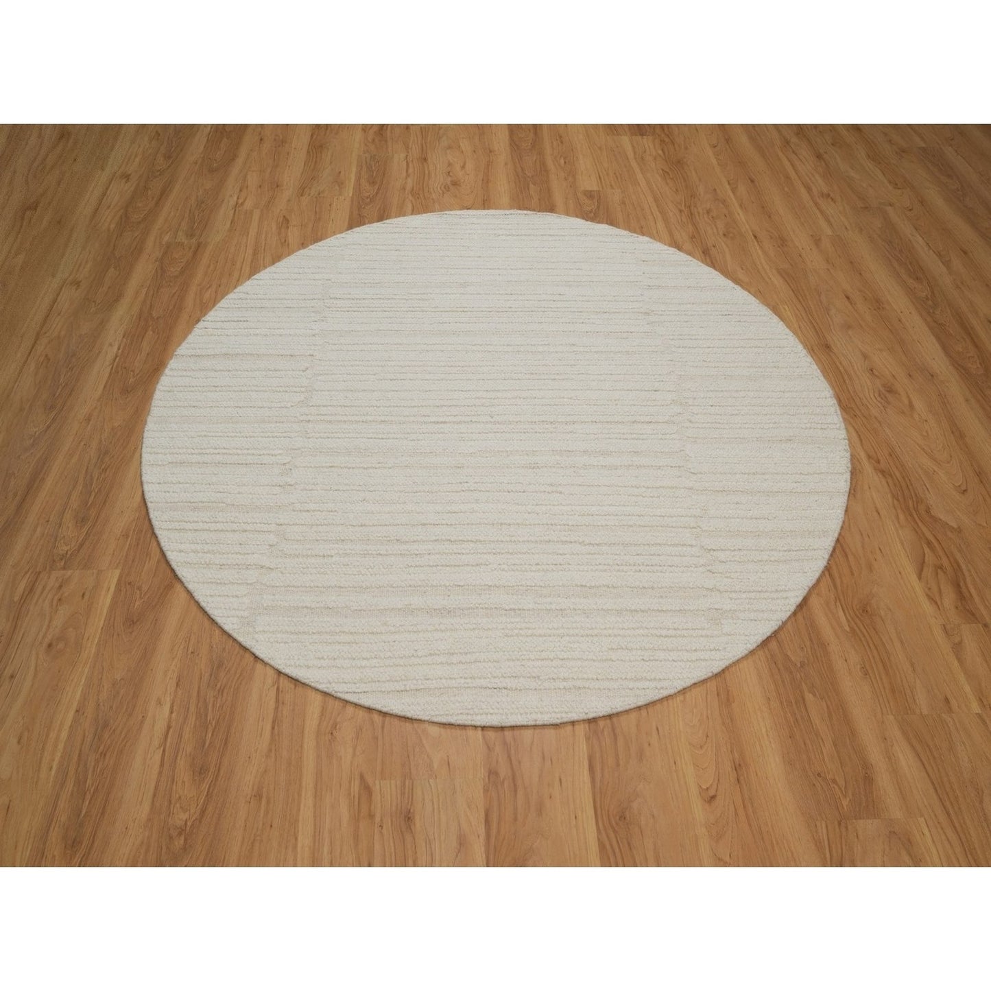 Hand knotted ivory wool with modern tone on tone textured round