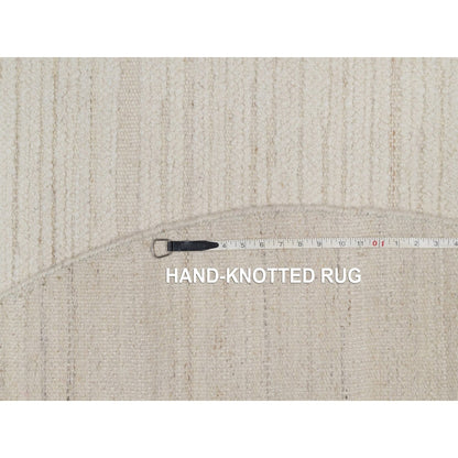 Hand knotted ivory wool with modern tone on tone textured round